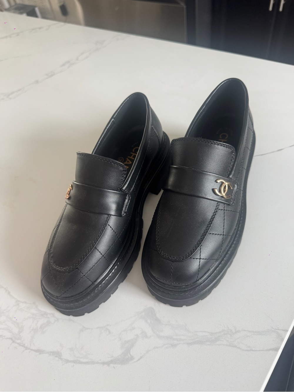 CHANEL Black Quilted Leather Penny Loafers with Gold CC Accent